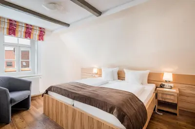 Ein Bett oder Betten in einem Zimmer der Unterkunft GDA Hotel Schwiecheldthaus