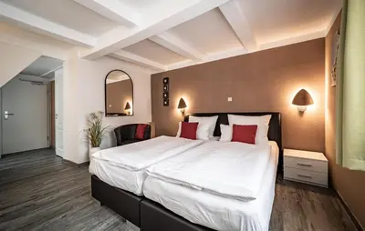Ein Bett oder Betten in einem Zimmer der Unterkunft Le petit Palais - Hotel/Pension