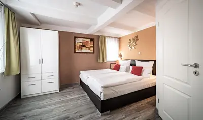 Ein Bett oder Betten in einem Zimmer der Unterkunft Le petit Palais - Hotel/Pension