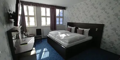 Ein Bett oder Betten in einem Zimmer der Unterkunft Hotel Alte Brennerei