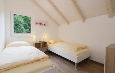 Ein Bett oder Betten in einem Zimmer der Unterkunft Ferienhausdorf Thale