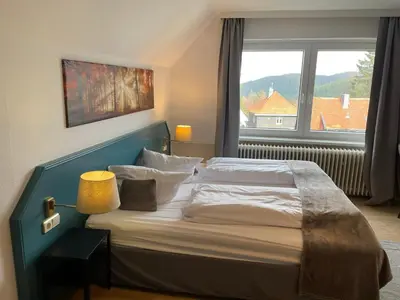 Ein Bett oder Betten in einem Zimmer der Unterkunft Berghotel HARZ