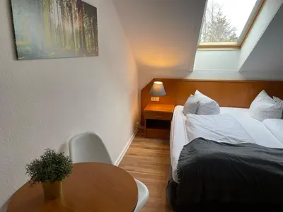 Ein Bett oder Betten in einem Zimmer der Unterkunft Berghotel HARZ