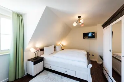 Ein Bett oder Betten in einem Zimmer der Unterkunft Zum fröhlichen Tagelöhner
