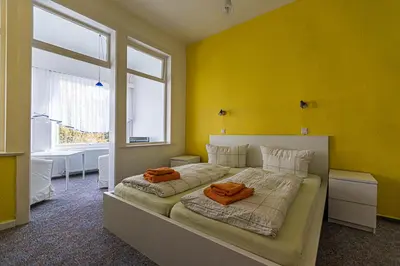 Ein Bett oder Betten in einem Zimmer der Unterkunft Ski und Biker Hotel Villa Sonnenschein Braunlage am Wurmberg