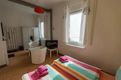 Ein Bett oder Betten in einem Zimmer der Unterkunft Ski und Biker Hotel Villa Sonnenschein Braunlage am Wurmberg