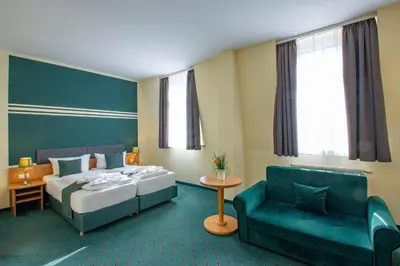 Ein Bett oder Betten in einem Zimmer der Unterkunft Ferien Hotel Villa Südharz