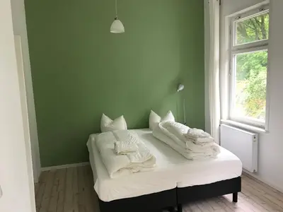 Ein Bett oder Betten in einem Zimmer der Unterkunft das weisse Haus am Fluss