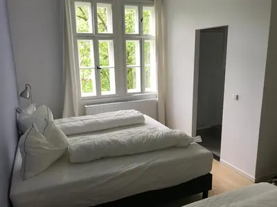 Ein Bett oder Betten in einem Zimmer der Unterkunft das weisse Haus am Fluss