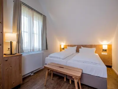 Ein Bett oder Betten in einem Zimmer der Unterkunft Ferienhäuser, Torfhaus