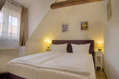 Ein Bett oder Betten in einem Zimmer der Unterkunft Urlaub im Fachwerk - Das Sattlerhaus