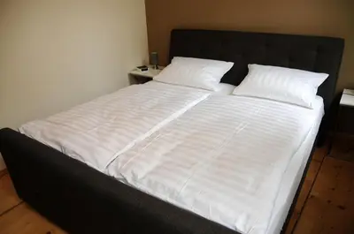 Ein Bett oder Betten in einem Zimmer der Unterkunft Apartments am Brunnen