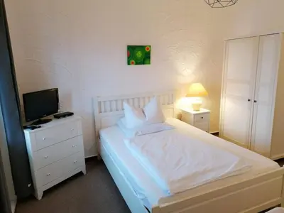 Ein Bett oder Betten in einem Zimmer der Unterkunft Pension Sonnenhof
