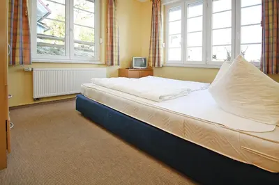 Ein Bett oder Betten in einem Zimmer der Unterkunft Ferienhäuser im Tannenpark, Tanne