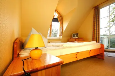 Ein Bett oder Betten in einem Zimmer der Unterkunft Ferienhäuser im Tannenpark, Tanne