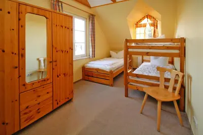 Ein Bett oder Betten in einem Zimmer der Unterkunft Ferienhäuser im Tannenpark, Tanne