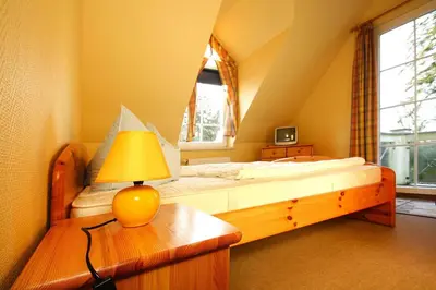 Ein Bett oder Betten in einem Zimmer der Unterkunft Ferienhäuser im Tannenpark, Tanne