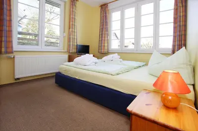 Ein Bett oder Betten in einem Zimmer der Unterkunft Ferienhäuser im Tannenpark, Tanne