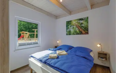 Ein Bett oder Betten in einem Zimmer der Unterkunft Ferienhausdorf Thale