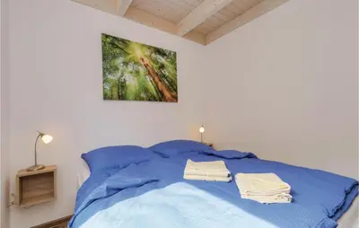 Ein Bett oder Betten in einem Zimmer der Unterkunft Ferienhausdorf Thale