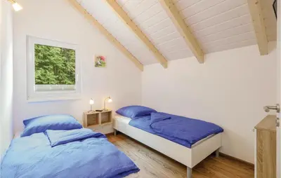 Ein Bett oder Betten in einem Zimmer der Unterkunft Ferienhausdorf Thale
