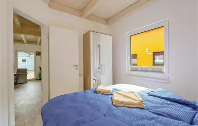 Ein Bett oder Betten in einem Zimmer der Unterkunft Ferienhausdorf Thale