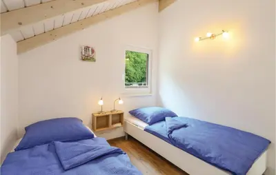 Ein Bett oder Betten in einem Zimmer der Unterkunft Ferienhausdorf Thale