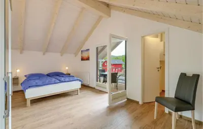 Ein Bett oder Betten in einem Zimmer der Unterkunft Ferienhausdorf Thale