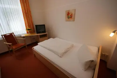 Ein Bett oder Betten in einem Zimmer der Unterkunft Hotel und Cafe Panorama