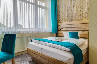 Ein Bett oder Betten in einem Zimmer der Unterkunft Panorama Ferien Hotel Harz