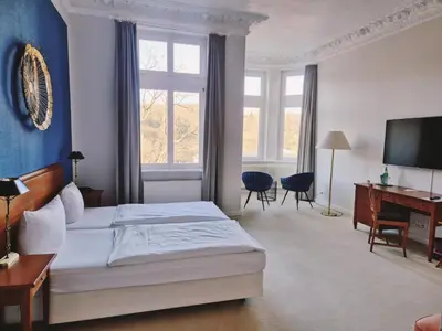 Ein Bett oder Betten in einem Zimmer der Unterkunft Hotel Villa Viktoria Luise
