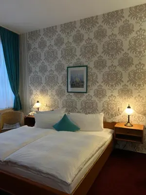 Ein Bett oder Betten in einem Zimmer der Unterkunft Hotel Am Grudenberg