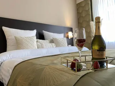 Ein Bett oder Betten in einem Zimmer der Unterkunft REGIOHOTEL Berghotel Ilsenburg - #Panoramablick #Wellness #Wallbox #GroßesAbendbuffet