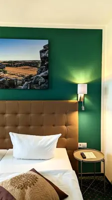 Ein Bett oder Betten in einem Zimmer der Unterkunft Acron-Hotel Quedlinburg