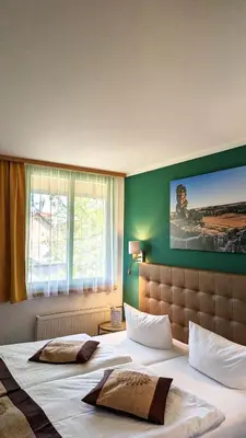 Ein Bett oder Betten in einem Zimmer der Unterkunft Acron-Hotel Quedlinburg