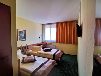Ein Bett oder Betten in einem Zimmer der Unterkunft Acron-Hotel Quedlinburg