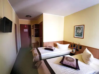Ein Bett oder Betten in einem Zimmer der Unterkunft Acron-Hotel Quedlinburg