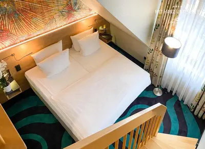 Ein Bett oder Betten in einem Zimmer der Unterkunft HKK Hotel Wernigerode