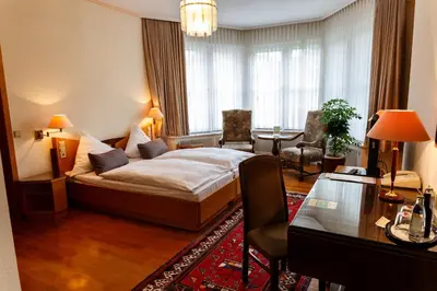 Ein Bett oder Betten in einem Zimmer der Unterkunft Parkhotel Unter den Linden