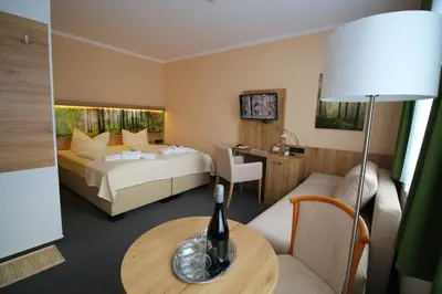 Ein Bett oder Betten in einem Zimmer der Unterkunft Hotel Harzresidenz