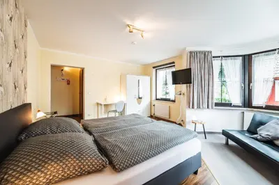 Ein Bett oder Betten in einem Zimmer der Unterkunft Landhotel Alte Aue