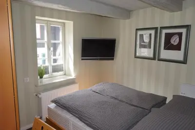 Ein Bett oder Betten in einem Zimmer der Unterkunft Altstadtperle Wernigerode