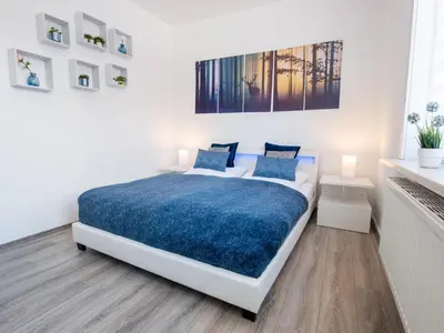 Ein Bett oder Betten in einem Zimmer der Unterkunft EUPHORAS - Modern eingerichtete Ferienwohnung mit 3 Schlafzimmern im Harz