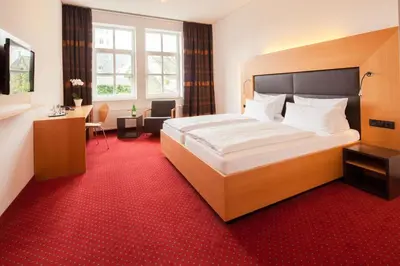Ein Bett oder Betten in einem Zimmer der Unterkunft Hotel Der Achtermann