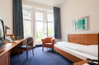 Ein Bett oder Betten in einem Zimmer der Unterkunft Hotel Der Achtermann