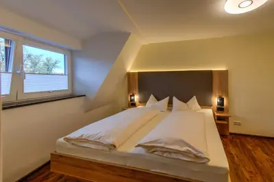 Ein Bett oder Betten in einem Zimmer der Unterkunft Heidequartier Harz