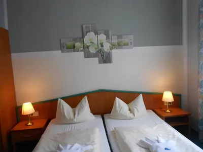 Ein Bett oder Betten in einem Zimmer der Unterkunft Ferienhotel Forelle Thale Ortsteil Treseburg