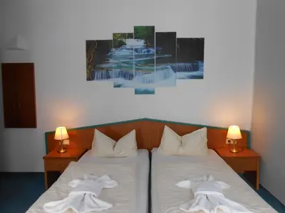 Ein Bett oder Betten in einem Zimmer der Unterkunft Ferienhotel Forelle Thale Ortsteil Treseburg