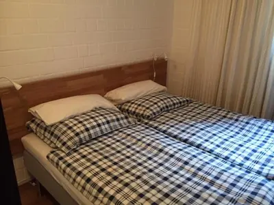 Ein Bett oder Betten in einem Zimmer der Unterkunft Roter Bär im Quellenweg