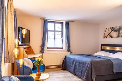 Ein Bett oder Betten in einem Zimmer der Unterkunft Schlossberg Hotel Wernigerode